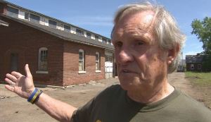 Former homeless veteran Jerry Readmond standing outside the historic Fort Snelling horse stables that will be converted into affordable housing for homeless veterans.  (Photo by Rod Wermager)